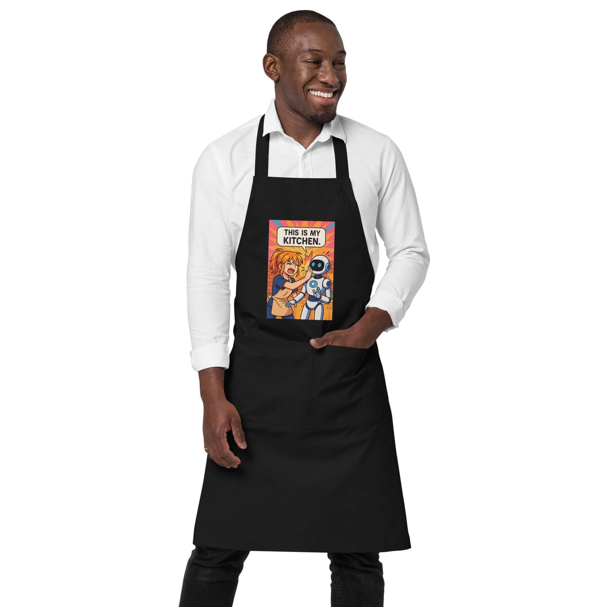 Man wearing an Organic cotton apron with anime design saying 'This is my kitchen' while smiling.