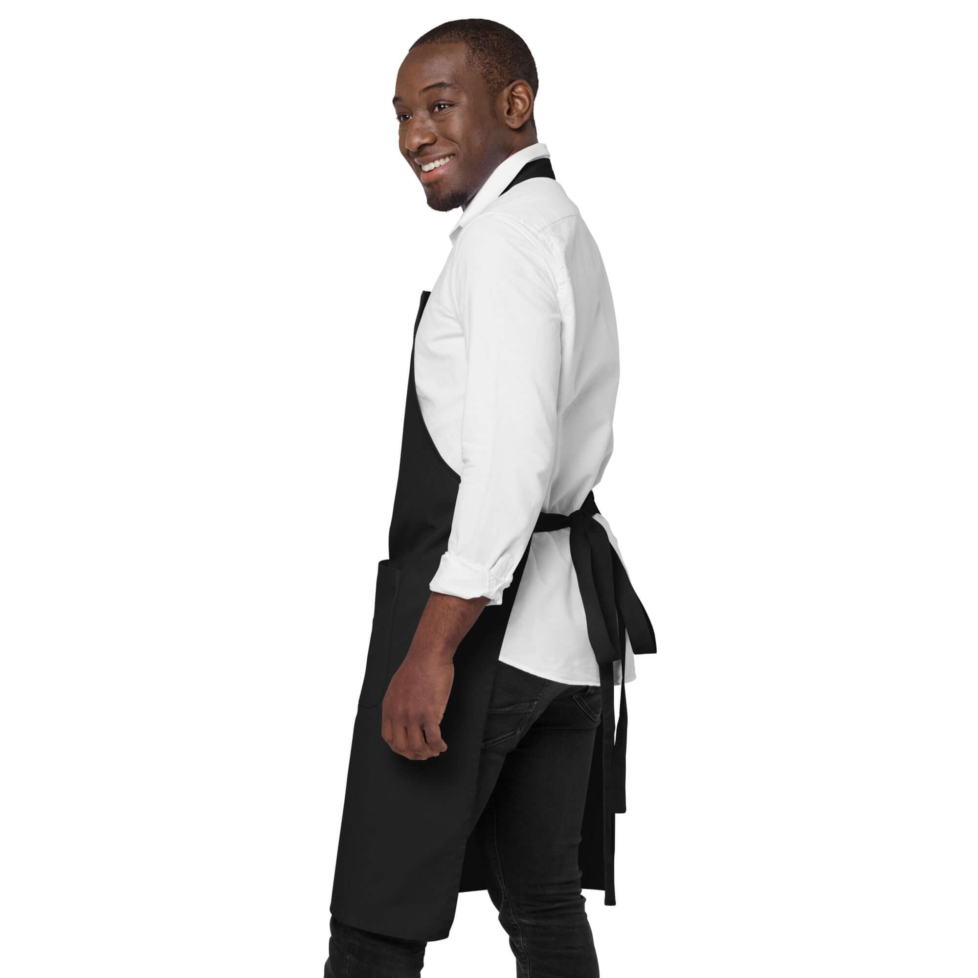 Model wearing an organic cotton apron, smiling, showcasing its style and functionality.