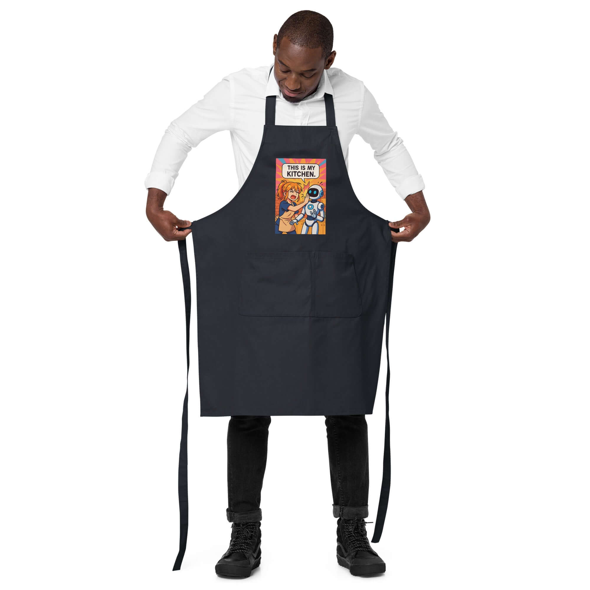 Organic cotton apron with playful design being worn by a man, perfect for cooking in style.