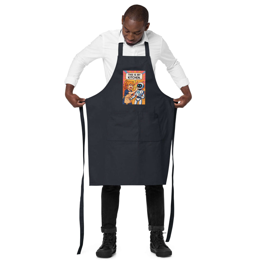 Organic cotton apron with playful design being worn by a man, perfect for cooking in style.