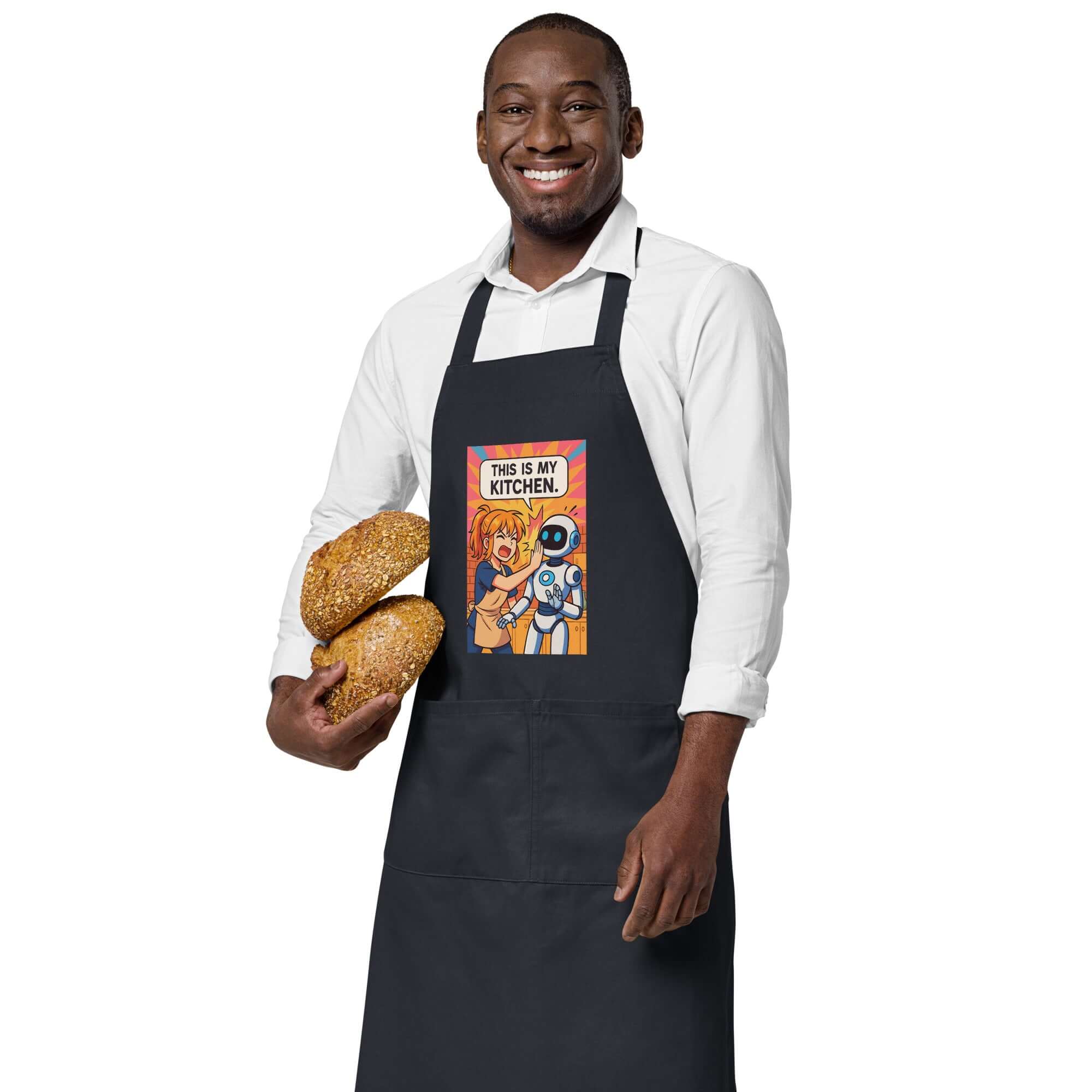 Man in an organic cotton apron featuring anime design, holding freshly baked bread, showcasing kitchen style.